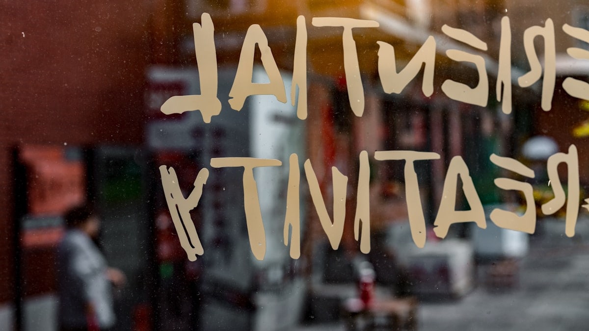 A window with a sign that says existent creativity